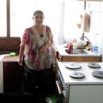 Leonarda Dibrani poses in her kitchen in the town of Mitrovica