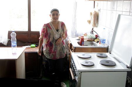 Leonarda Dibrani poses in her kitchen in the town of Mitrovica