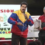 Venezuela's President Maduro shows a picture of a metro tunnel wall with an image which he says is the face of late President Chavez, in Caracas