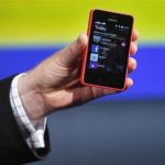 A Nokia official displays a new $99 phone in its mid-range Asha line at a launch in New Delhi