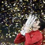 Djokovic of Serbia kisses the trophy after winning the men's singles final match against Del Potro of Argentina at the Shanghai Masters tennis tournament