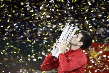 Djokovic of Serbia kisses the trophy after winning the men's singles final match against Del Potro of Argentina at the Shanghai Masters tennis tournament