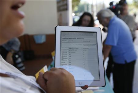 A woman explains healthcare benefits at a Covered California event in Los Angeles