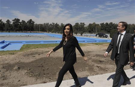 Argentine President Fernandez walks ahead of Lower House candidate Insaurralde in Buenos Aires