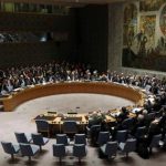 Members of the United Nations Security Council raise their hands as they vote unanimously to approve a resolution eradicating Syria's chemical arsenal in New York