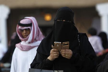 File photo of woman using an iPhone visiting the 27th Janadriya festival on the outskirts of Riyadh