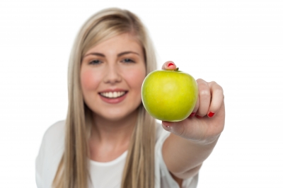 Smiling Girl Displaying Fresh Green Apple