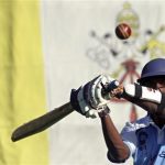 A player from a team of priests and seminarians returns a ball during a training session in Rome