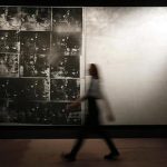 A Sotheby's employee poses with Warhol's artwork "Silver Car Crash" at Sotheby's auction house in London