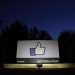 The sun rises behind the entrance sign to Facebook headquarters in Menlo Park before the company's IPO launch,