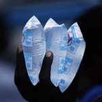 A resident holds packets of water to sell in downtown Port-au-Prince