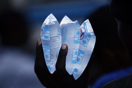 A resident holds packets of water to sell in downtown Port-au-Prince