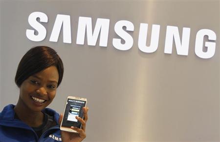 A Samsung employee holds a mobile phone at a Samsung display store in Johannesburg