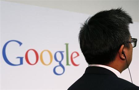A man stands in front of a Google logo in Hong Kong