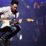 Maroon 5 lead singer Adam Levine jumps as they perform during the iHeartRadio Music Festival in Las Vegas