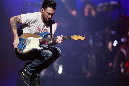 Maroon 5 lead singer Adam Levine jumps as they perform during the iHeartRadio Music Festival in Las Vegas