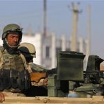 Afghan policemen keep watch at the area where the Loya Jirga will take place later this week, in Kabul