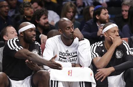 Andray Blatche, left, Kevin Garnett (2) and Paul Pierce