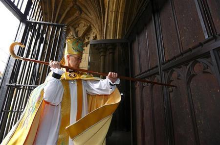 The new Archbishop of Canterbury Justin Welby knocks on the door of Canterbury Cathedral as he arrives for his enthronement ceremony, in Canterbury, southern England