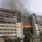 Smoke rises from a fire burning at a Standard Group garment factory in Gazipur