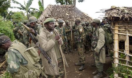 Congolese soldiers gather for a military brief after M23 rebel fighters surrendered in Chanzo village in the Rutshuru territory near the eastern town of Goma