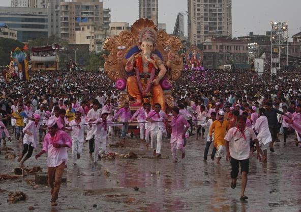Devotees pull an idol of Hindu elephant god Ganesh