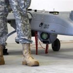 A soldier stands in front of a 'Shadow' drone during presentation by UAS at US military base in Vilseck-Grafenwoehr