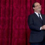 France's President Hollande reacts during a ceremony where he named French singer and actress Renaud "Grand Officier de la Legion d'Honneur" at the Elysee Palace in Paris