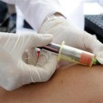 A nurse takes blood for a free HIV test on the National Day of HIV-AIDS testing in San Salvador