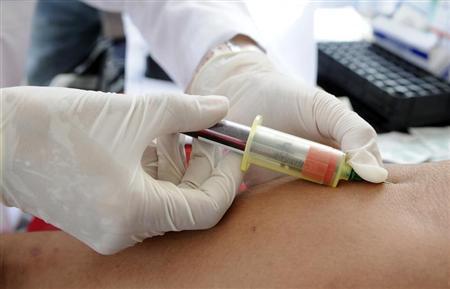 A nurse takes blood for a free HIV test on the National Day of HIV-AIDS testing in San Salvador