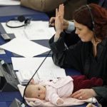 Denmark's member of the European Parliament Hanne Dahl and her baby attend a voting session at the European Parliament in Strasbourg
