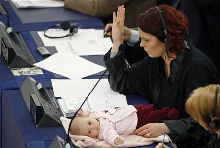 Denmark's member of the European Parliament Hanne Dahl and her baby attend a voting session at the European Parliament in Strasbourg