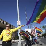 Don Fasone waves a flag in support of same sex marriage while the Hawaii State Senate convenes to approve the bill allowing same sex marriage to be legal in the state of Hawaii in Honolulu
