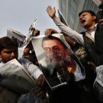 Activists of ABVP burn a poster of Tejpal during a protest in New Delhi