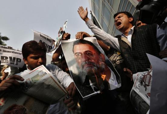 Activists of ABVP burn a poster of Tejpal during a protest in New Delhi