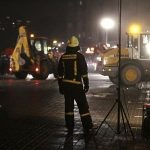 A firefighter watches the rescue operation at the site of the collapsed Maxima supermarket in Riga
