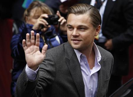 Actor DiCaprio waves to supporters as he arrives for a photocall to promote the movie "Shutter Island" at Berlinale in Berlin