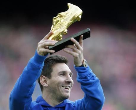 Barcelona's soccer player Lionel Messi poses with the Golden Boot trophy before their Spanish first division league match against Granada at Camp Nou stadium in Barcelona