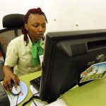 An employee registers a customer for a mobile money transfer inside the Safaricom mobile phone care centre in the central business district of Kenya's capital Nairobi