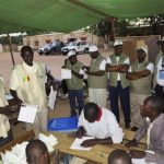 A delegation of the ECOWAS observer mission monitor the counting of cast votes at a polling station in Bamako