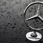 The emblem of German car manufacturer Mercedes-Benz, a subsidiary of Daimler AG, is pictured covered with raindrops at a parking lot in Hanau
