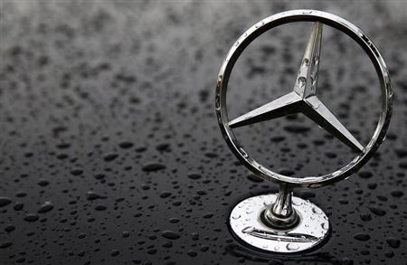 The emblem of German car manufacturer Mercedes-Benz, a subsidiary of Daimler AG, is pictured covered with raindrops at a parking lot in Hanau