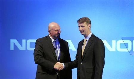 Microsoft CEO Ballmer shakes hands with Nokia's Chairman of the Board Siilasmaa during a Nokia news conference in Espoo