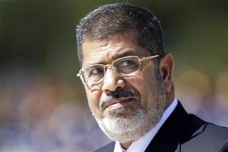 Egypt's President Mohamed Mursi reviews the troops in an official ceremony before a meeting with Brazil's President Dilma Rousseff at the Planalto Palace in Brasilia