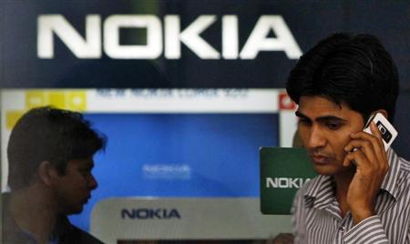 A customer speaks on his mobile phone as he comes out of a Nokia showroom in New Delhi