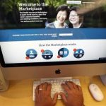A man looks over the Affordable Care Act signup page on the HealthCare.gov website in New York in this photo illustration
