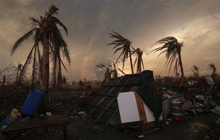 Part of a rainbow appears over the makeshift home of a family in Guiuan