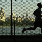 MAN JOGS ON RESAVOIR PATH IN NEW YORK'S CENTRAL PARK AS PARK NEARS 150TH ANNIVERSAY.