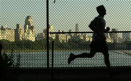 MAN JOGS ON RESAVOIR PATH IN NEW YORK'S CENTRAL PARK AS PARK NEARS 150TH ANNIVERSAY.
