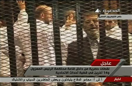 Video still shows ousted former Egyptian President Mursi in a courthouse on the first day of his trial, in Cairo